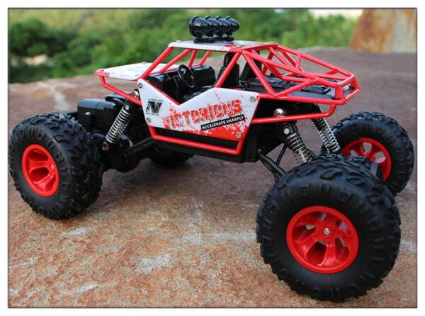 White and red remote controlled offroad car with lights on top of the roof